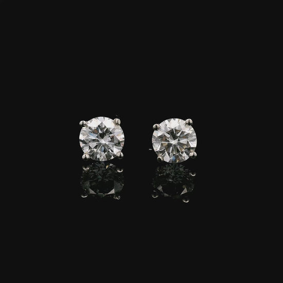 14K White gold stud earrings set with round brilliant diamonds. Item J38154 - ABC Jewelry Co