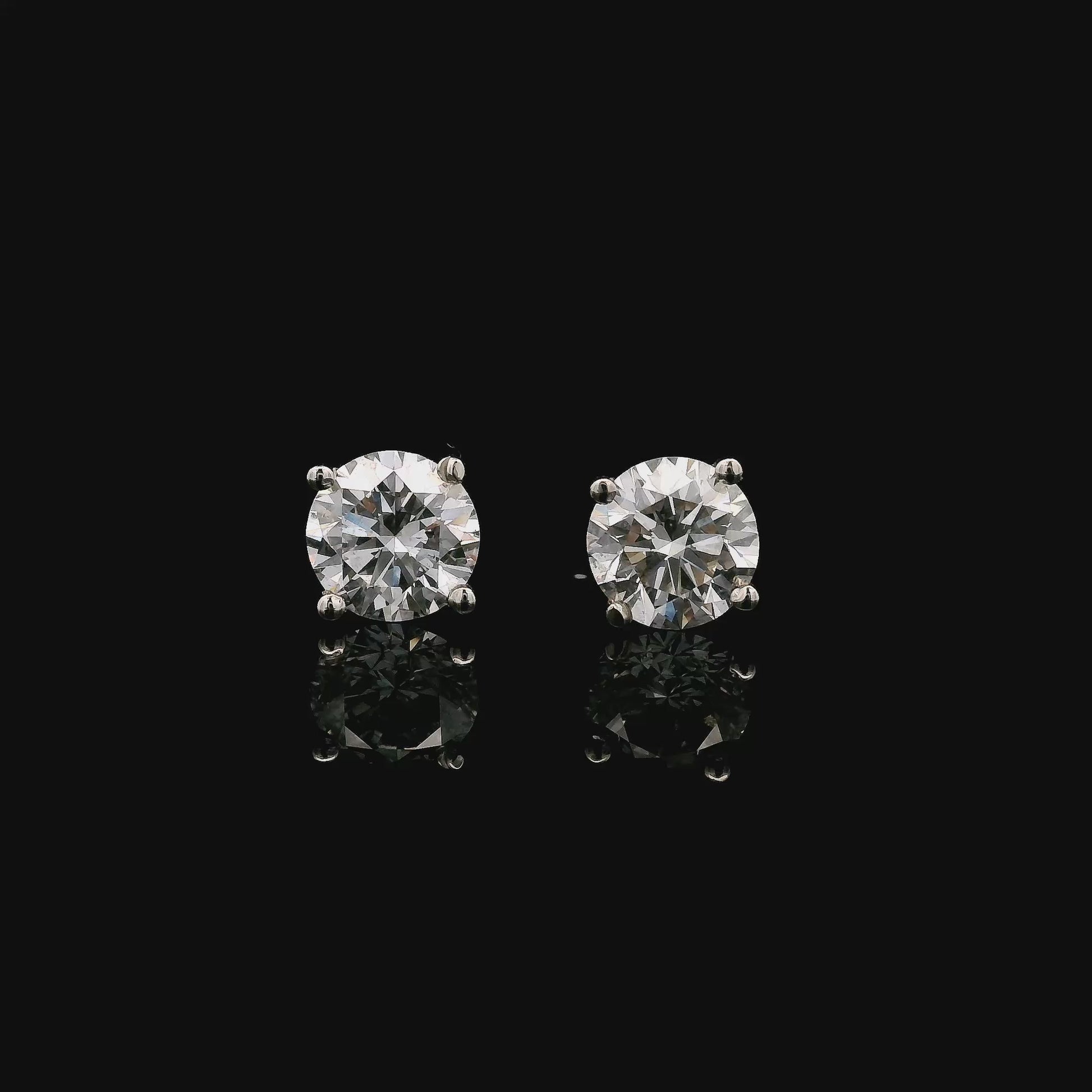 14K White gold stud earrings set with round brilliant diamonds. Item J38154 - ABC Jewelry Co