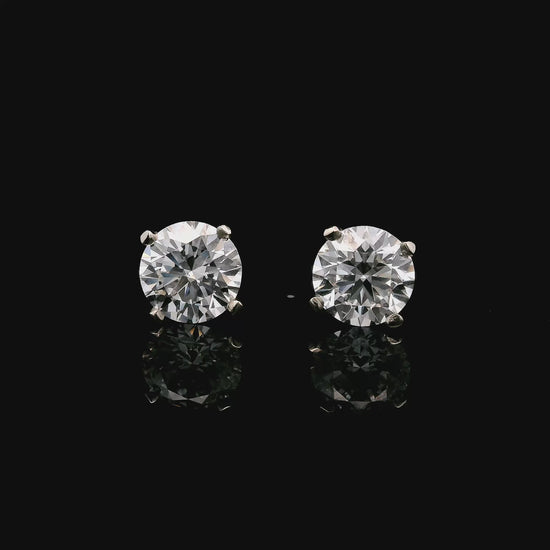14K White gold stud earrings set with 2 natural mined diamonds. Item J37802 - ABC Jewelry Co
