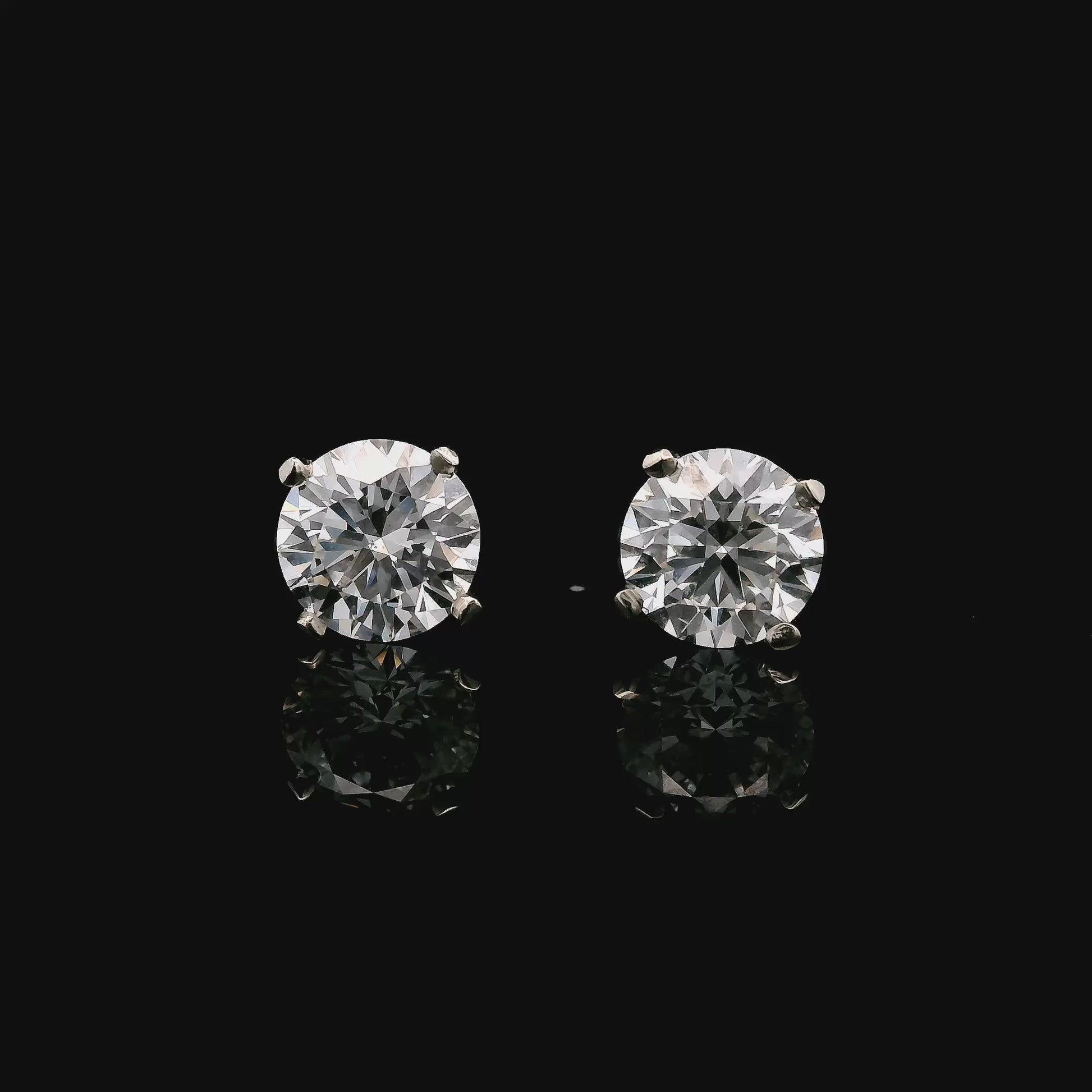 14K White gold stud earrings set with 2 natural mined diamonds. Item J37802 - ABC Jewelry Co