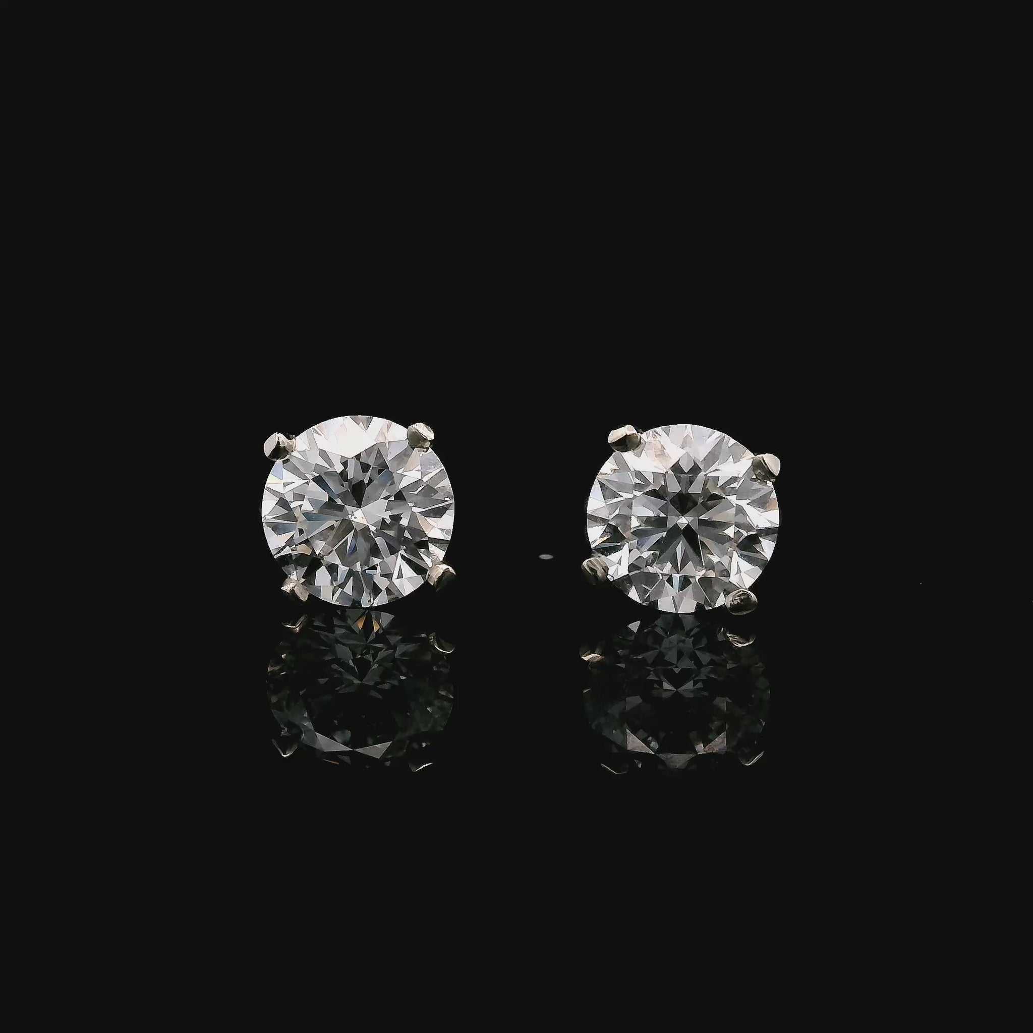 14K White gold stud earrings set with 2 natural mined diamonds. Item J37802 - ABC Jewelry Co