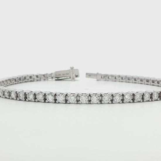 14K white gold tennis bracelet set with round brilliant diamonds. Item J38668 - ABC Jewelry Co.