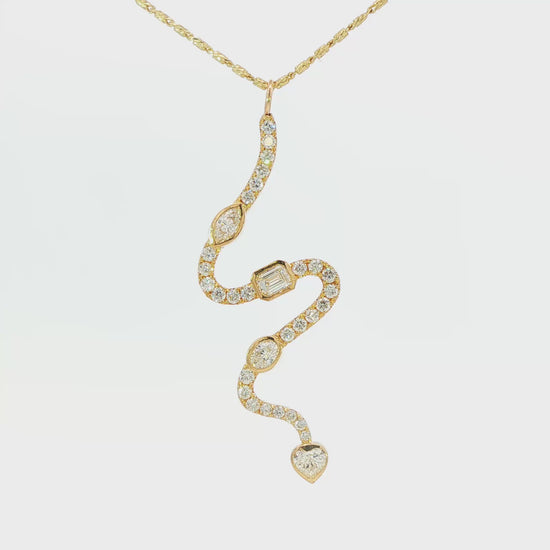 18K Yellow gold snake pendant set with natural mined diamonds of varying shapes. Item J38684 - ABC Jewelry Co. 