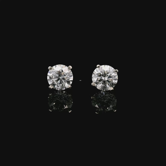 14K White gold stud earrings set with 2 round brilliant diamonds. Item J34919 - ABC Jewelry Co. 