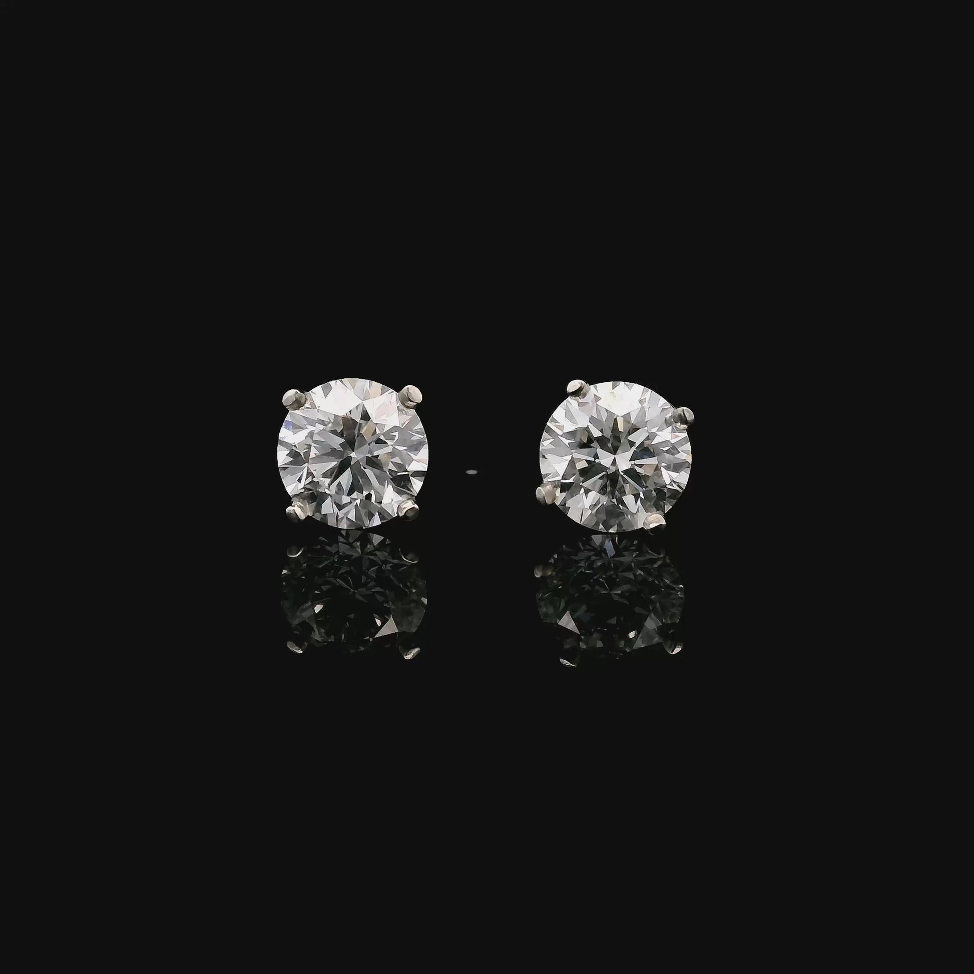 14K White gold stud earrings set with 2 round brilliant diamonds. Item J34919 - ABC Jewelry Co. 