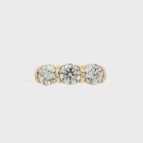 14K Yellow gold ring set with 3 round brilliant diamonds. Item J38945 - ABC Jewelry Co. 