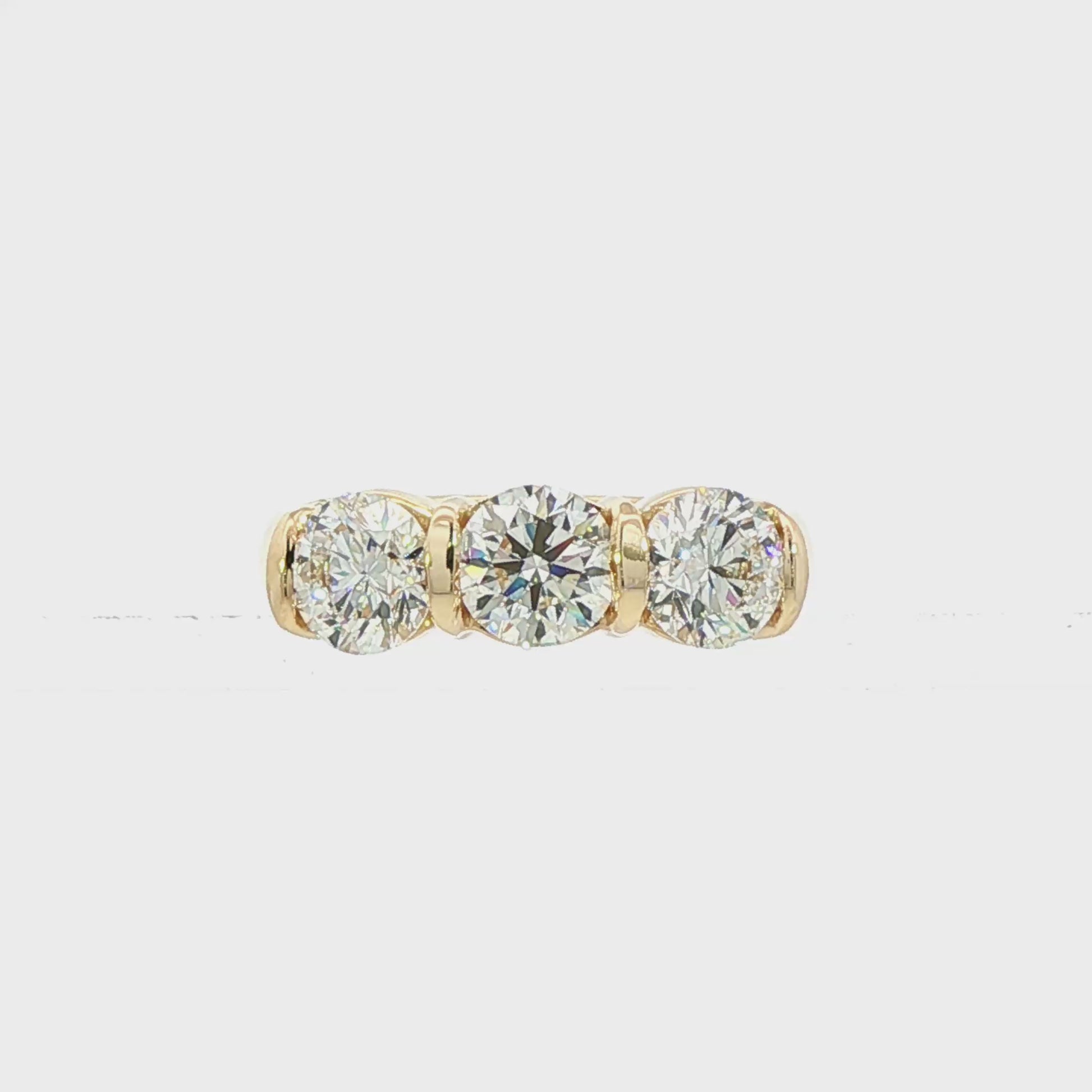 14K Yellow gold ring set with 3 round brilliant diamonds. Item J38945 - ABC Jewelry Co. 
