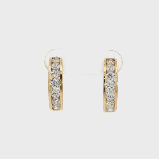 14K Yellow gold hoop earrings channel set with round brilliant diamonds. Item J38756 - ABC Jewelry Co.