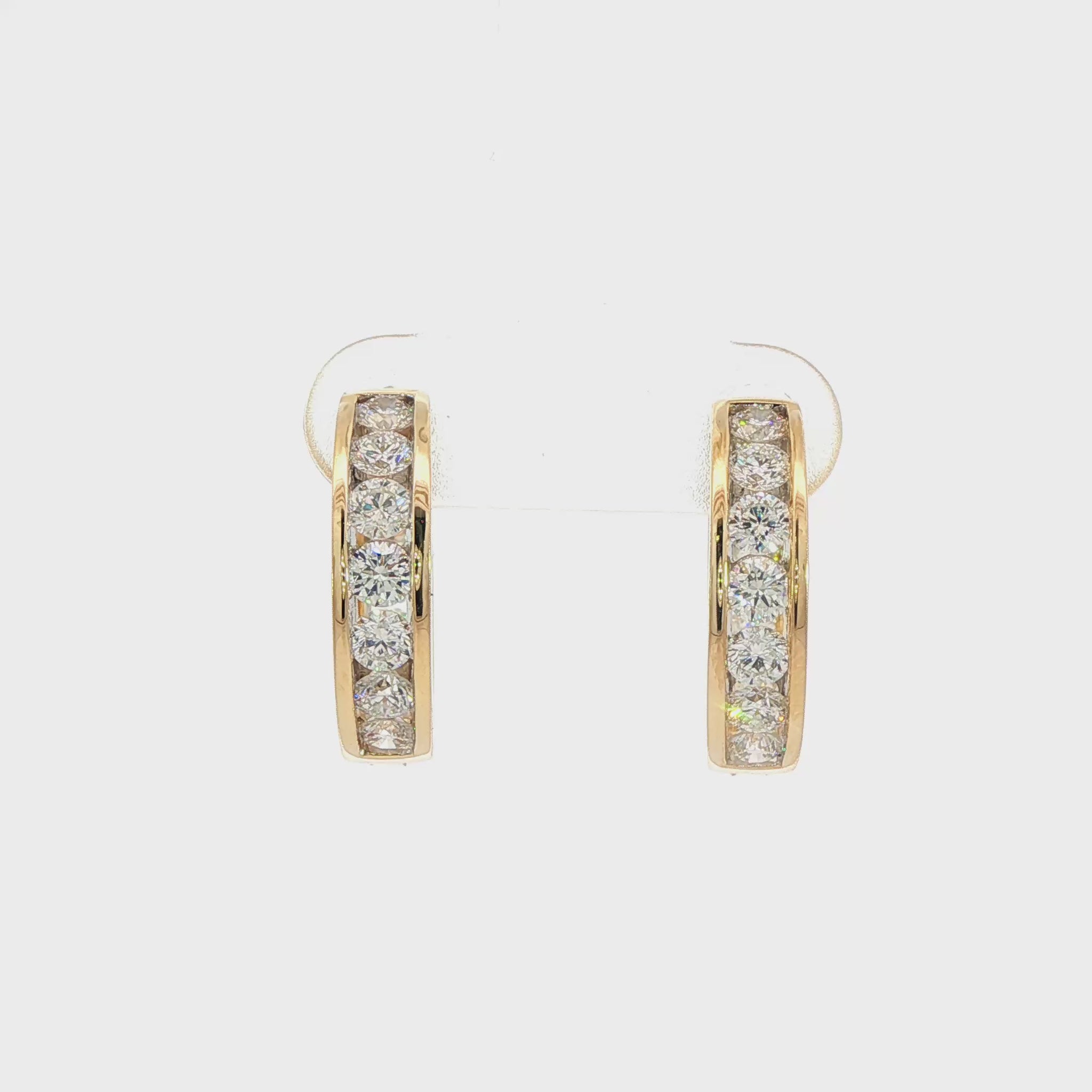 14K Yellow gold hoop earrings channel set with round brilliant diamonds. Item J38756 - ABC Jewelry Co.