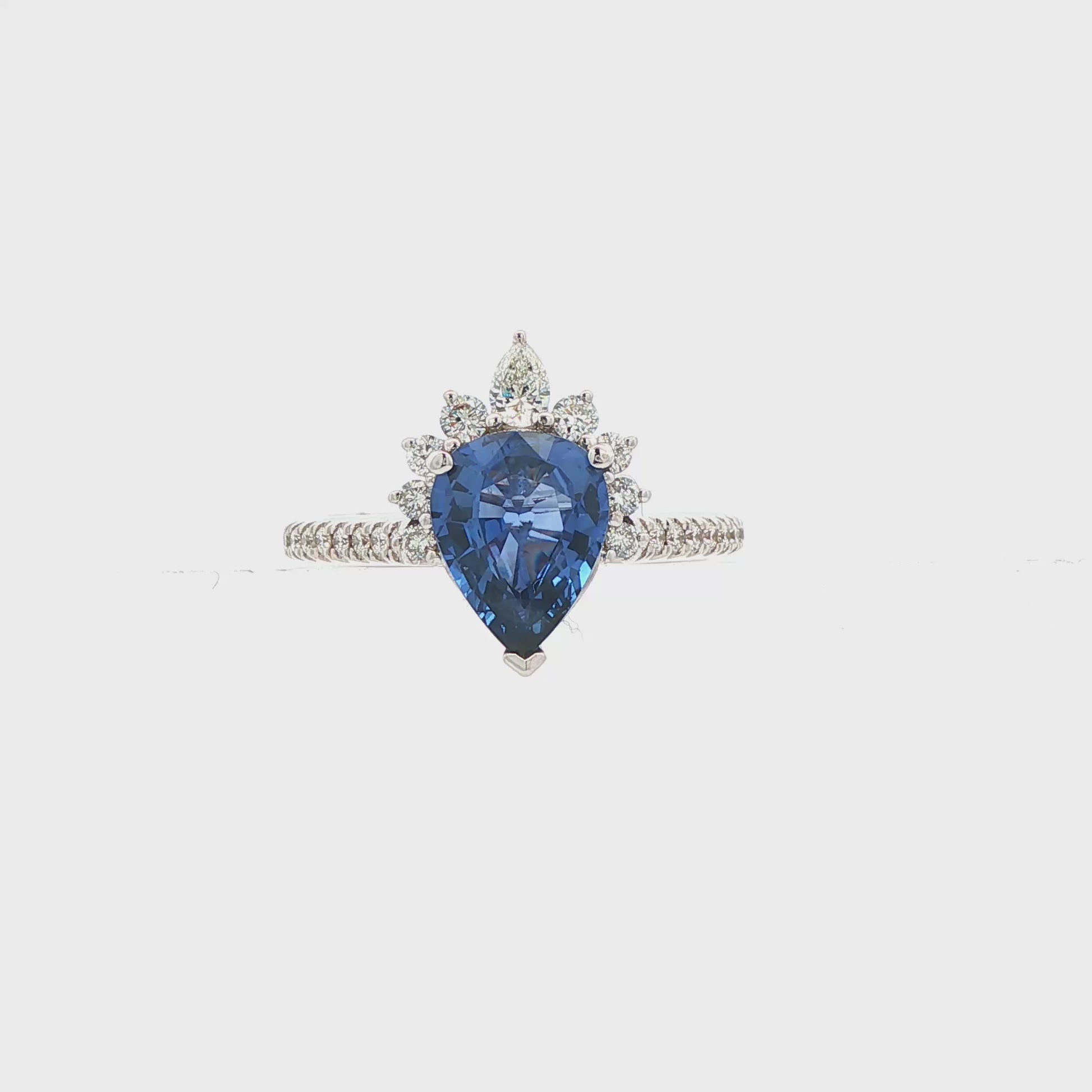 18K White gold ring set with a pear shape blue sapphire crowned with diamonds. Item J36871 - ABC Jewelry Co. 