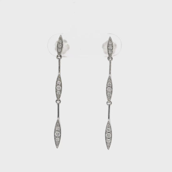 14K White gold dangle earrings with sets of round brilliant diamonds set along the length. Item J36044 - ABC Jewelry Co