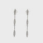 14K White gold dangle earrings with sets of round brilliant diamonds set along the length. Item J36044 - ABC Jewelry Co