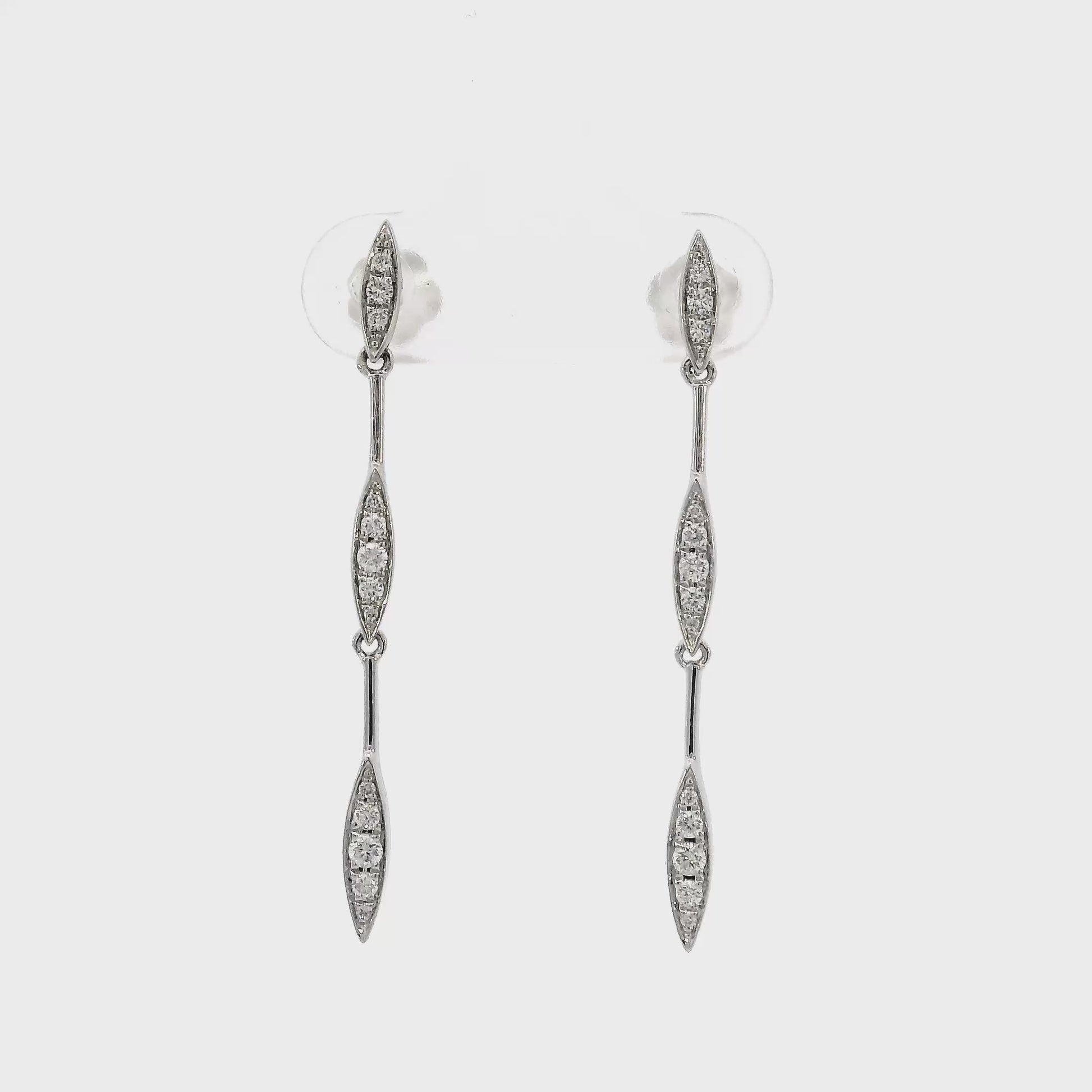 14K White gold dangle earrings with sets of round brilliant diamonds set along the length. Item J36044 - ABC Jewelry Co