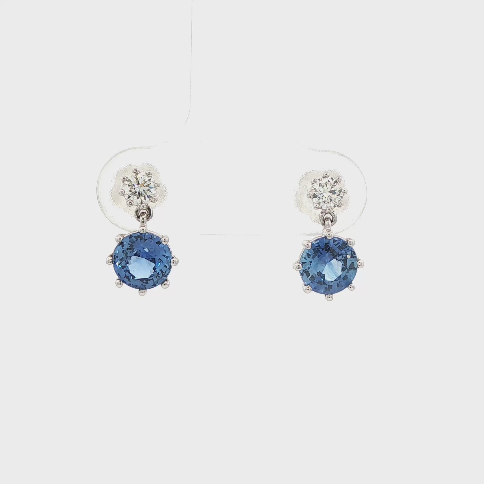 14K White gold drop earrings set with blue sapphires and round brilliant diamonds. Item J37495 - ABC Jewelry Co.