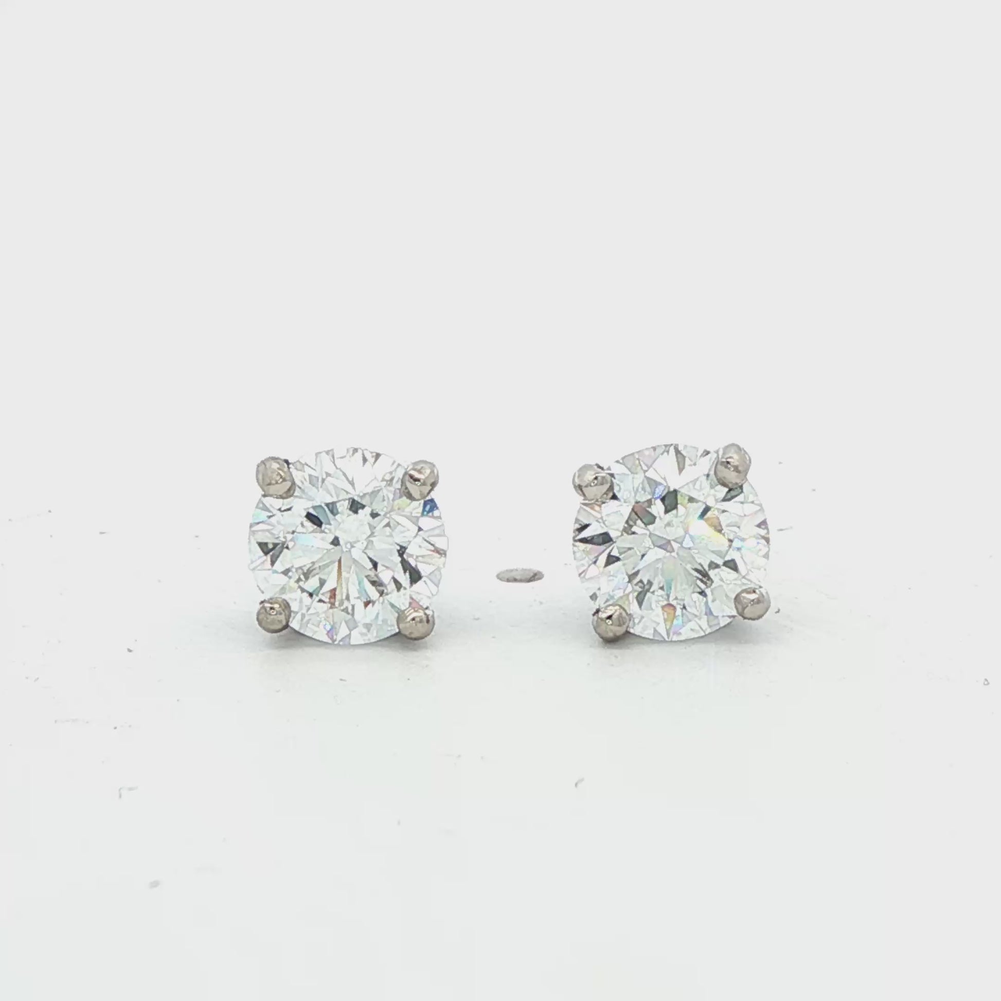 14K White gold diamond stud earrings. Item J38704 - ABC Jewelry Co.