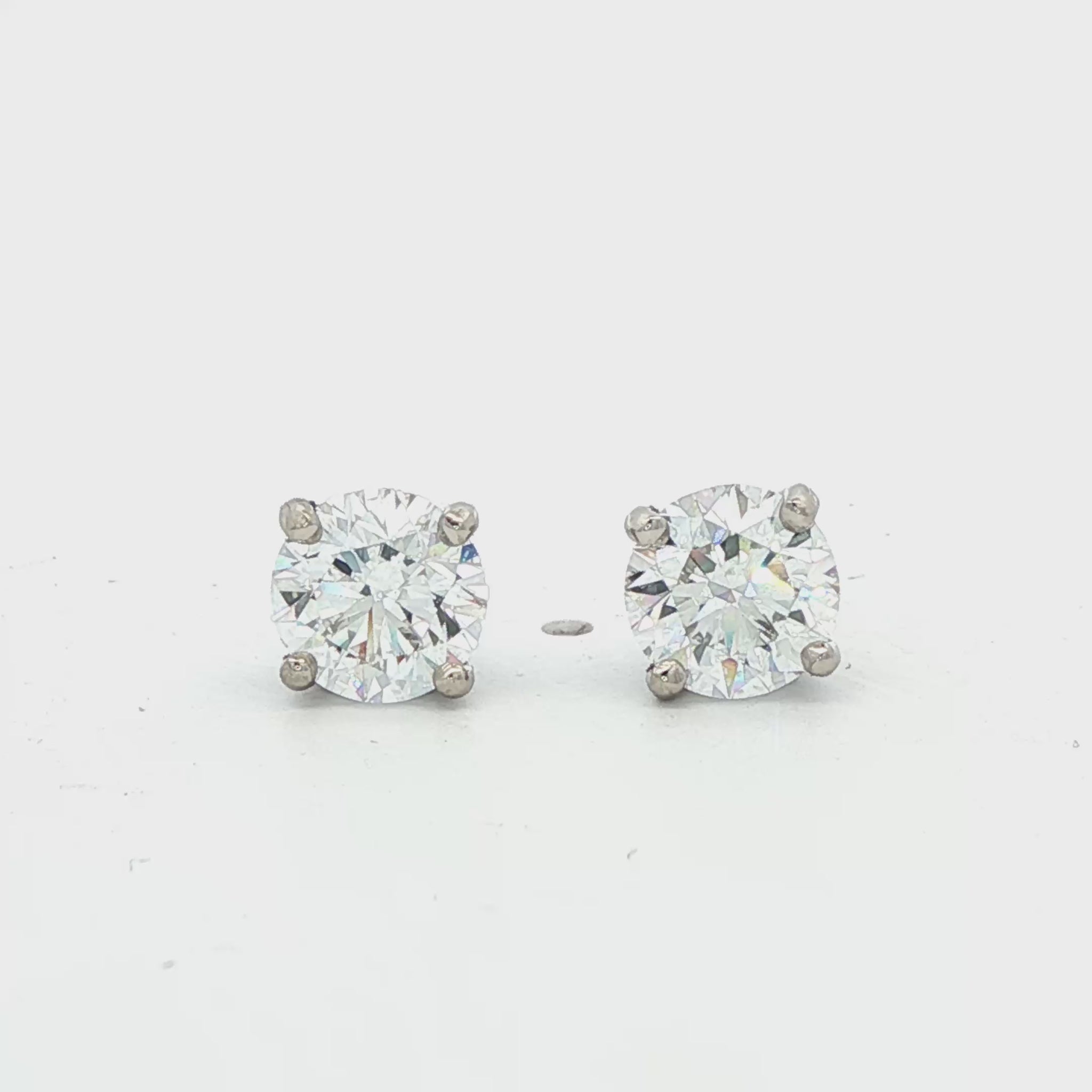 14K White gold diamond stud earrings. Item J38704 - ABC Jewelry Co.
