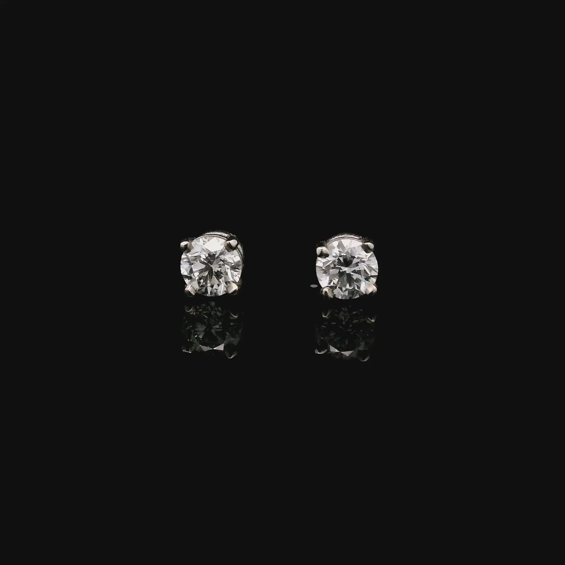 14K White gold stud earrings set with round brilliant diamonds. Item J33030 - ABC Jewelry Co.