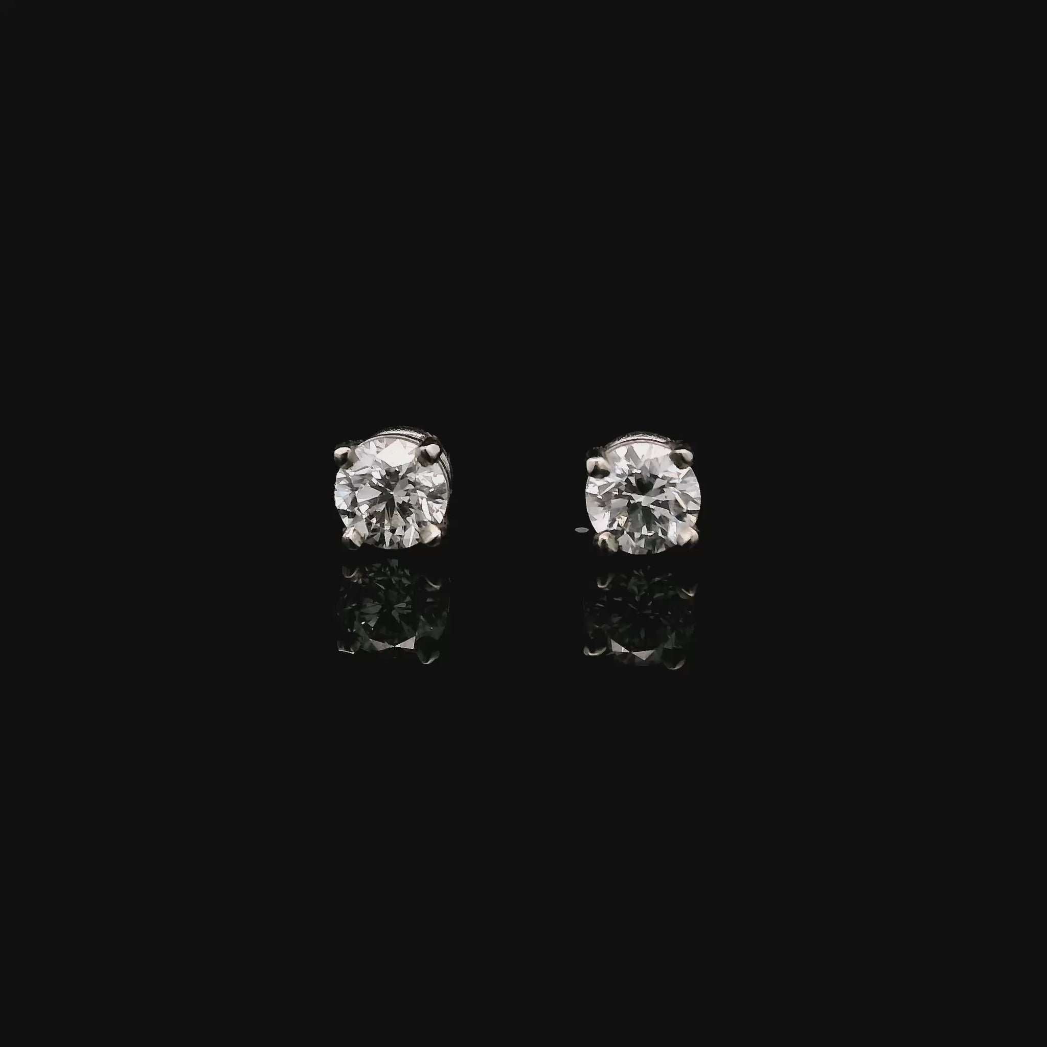 14K White gold stud earrings set with round brilliant diamonds. Item J33030 - ABC Jewelry Co.