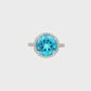 14K White gold ring with a round blue topaz and diamond halo. Item J38755 - ABC Jewelry Co. 