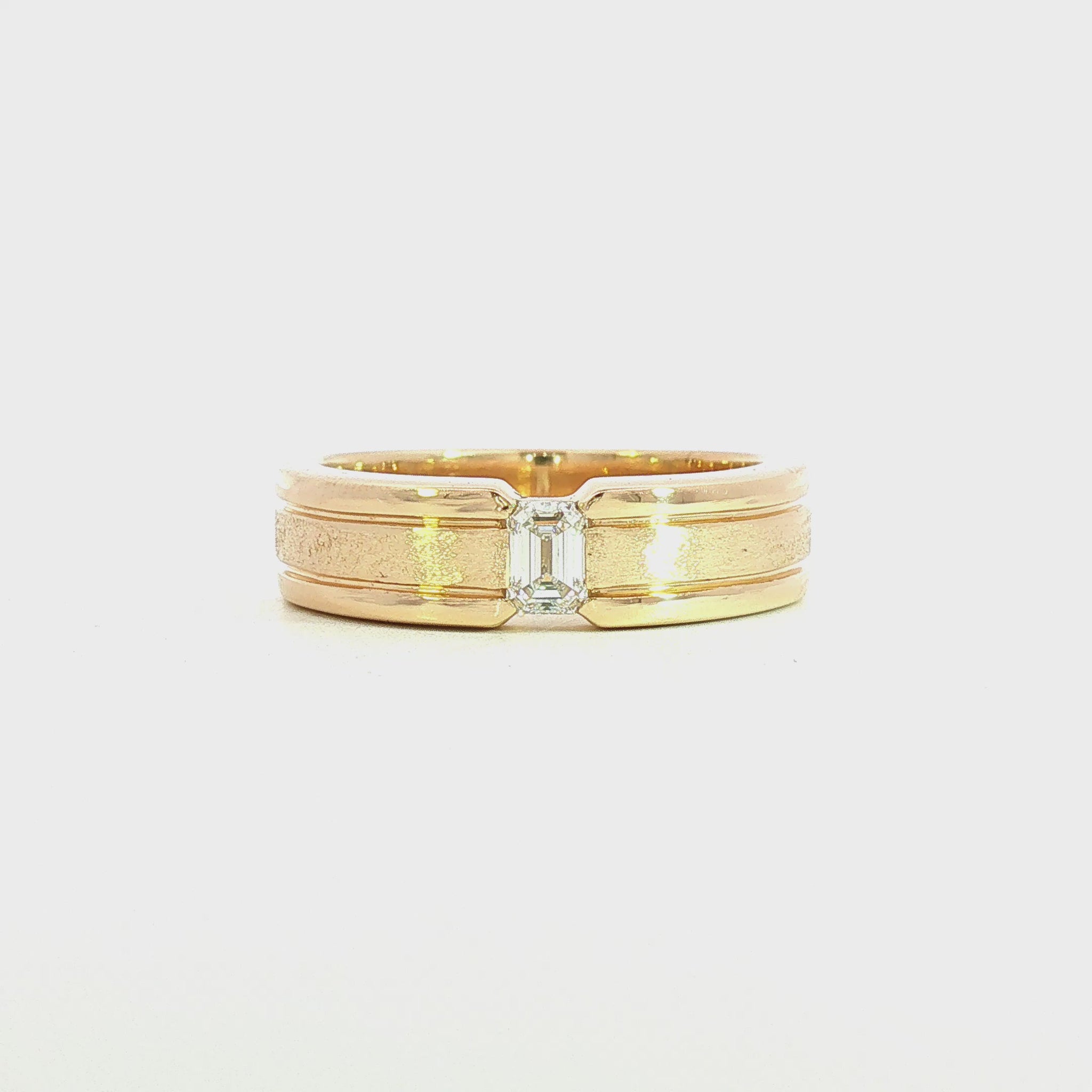 14K Yellow gold ring with satin finish inner band and polished edges, set with emerald cut diamond. Item J39319