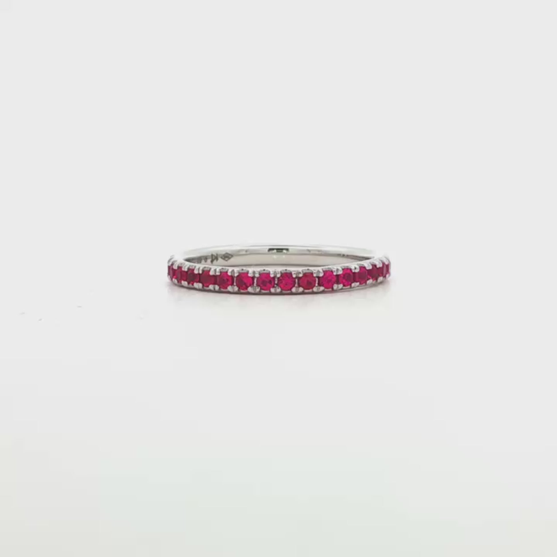 18K White gold eternity band set with brilliant cut rubies. Item J37475 - ABC Jewelry Co. 