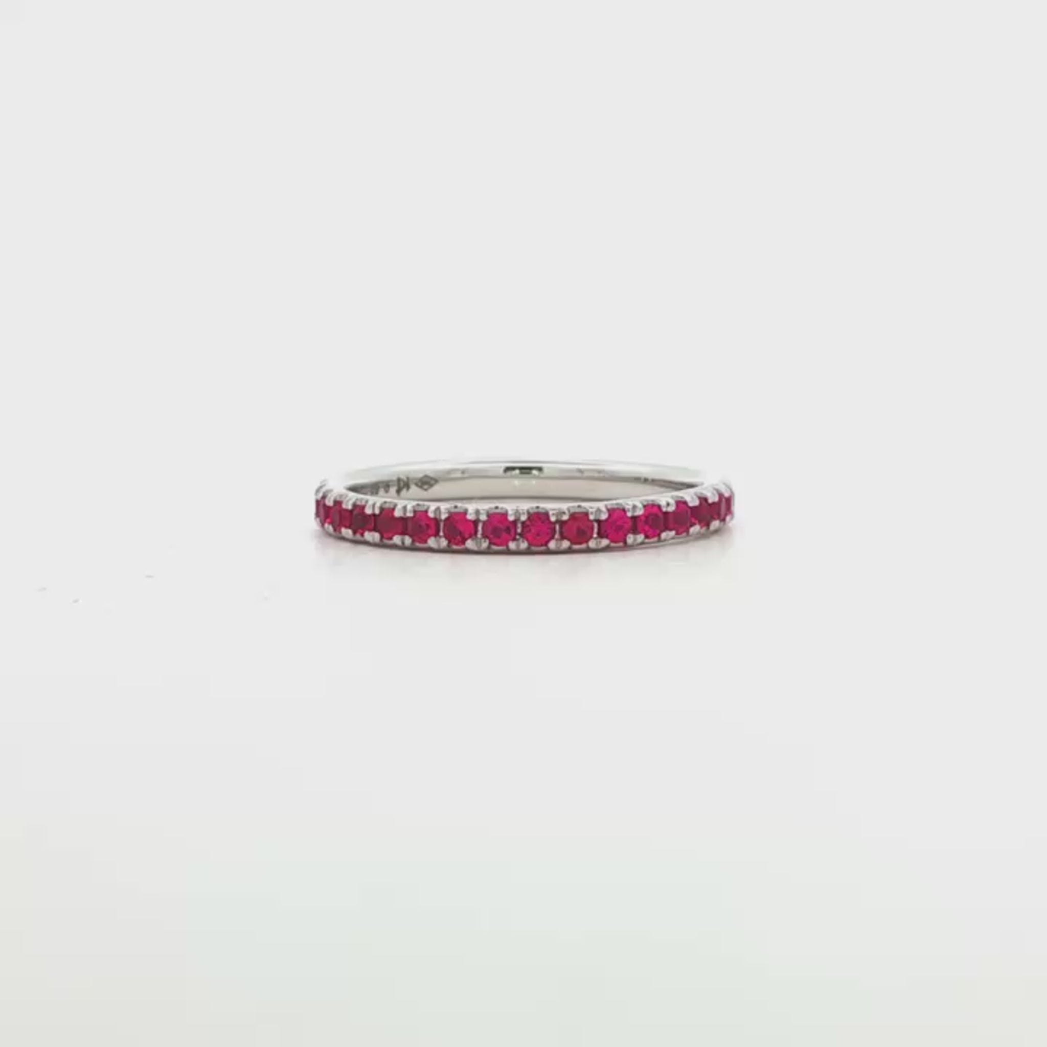18K White gold eternity band set with brilliant cut rubies. Item J37475 - ABC Jewelry Co. 