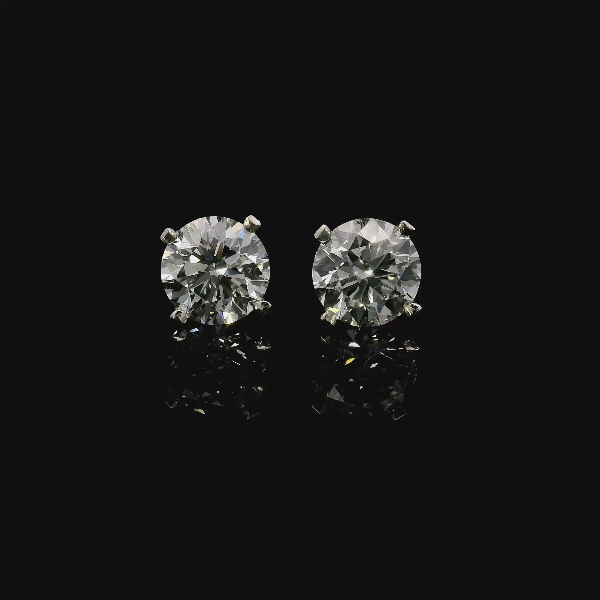 14K White gold stud earrings set with round brilliant diamonds. Item J37811 - ABC Jewelry Co.