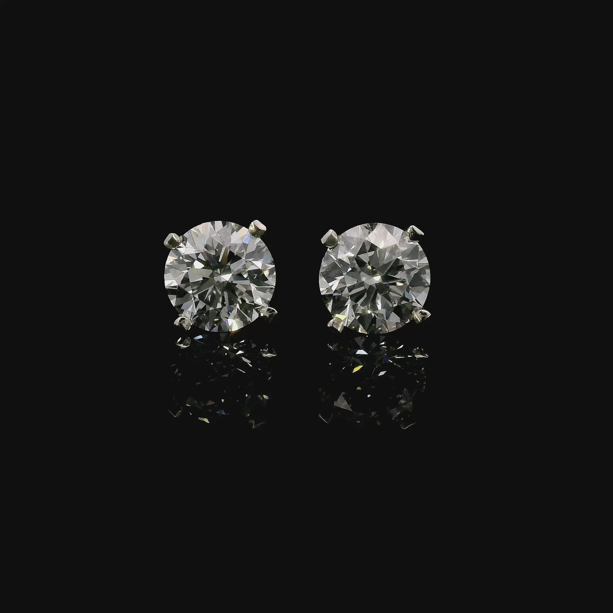 14K White gold stud earrings set with round brilliant diamonds. Item J37811 - ABC Jewelry Co.