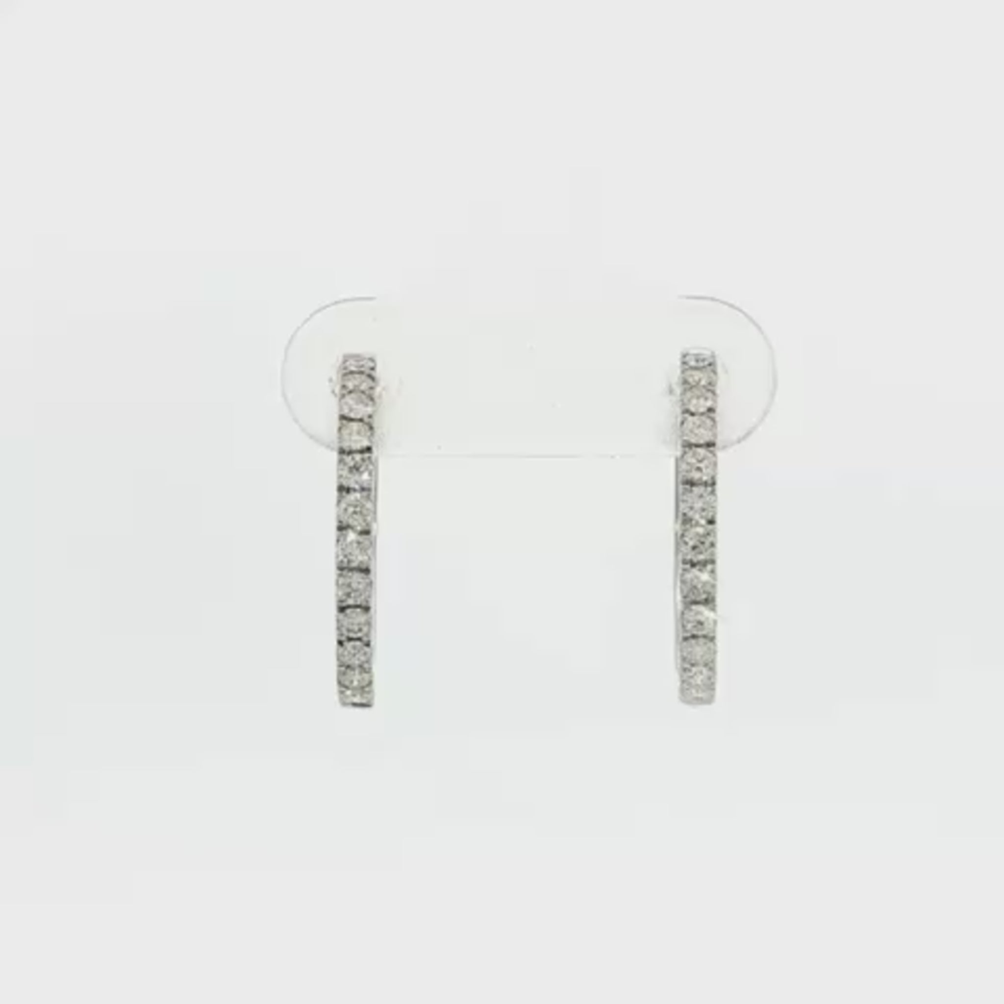 18K White gold hoop earrings set with a row of round brilliant diamonds. Item J36133 - ABC Jewelry Co. 