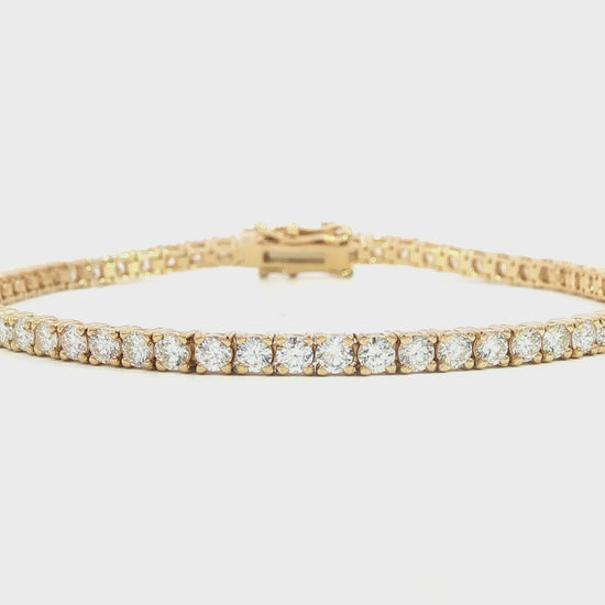 14K Yellow gold tennis bracelet set with round brilliant diamonds. Item J38987 - ABC Jewelry Co. 