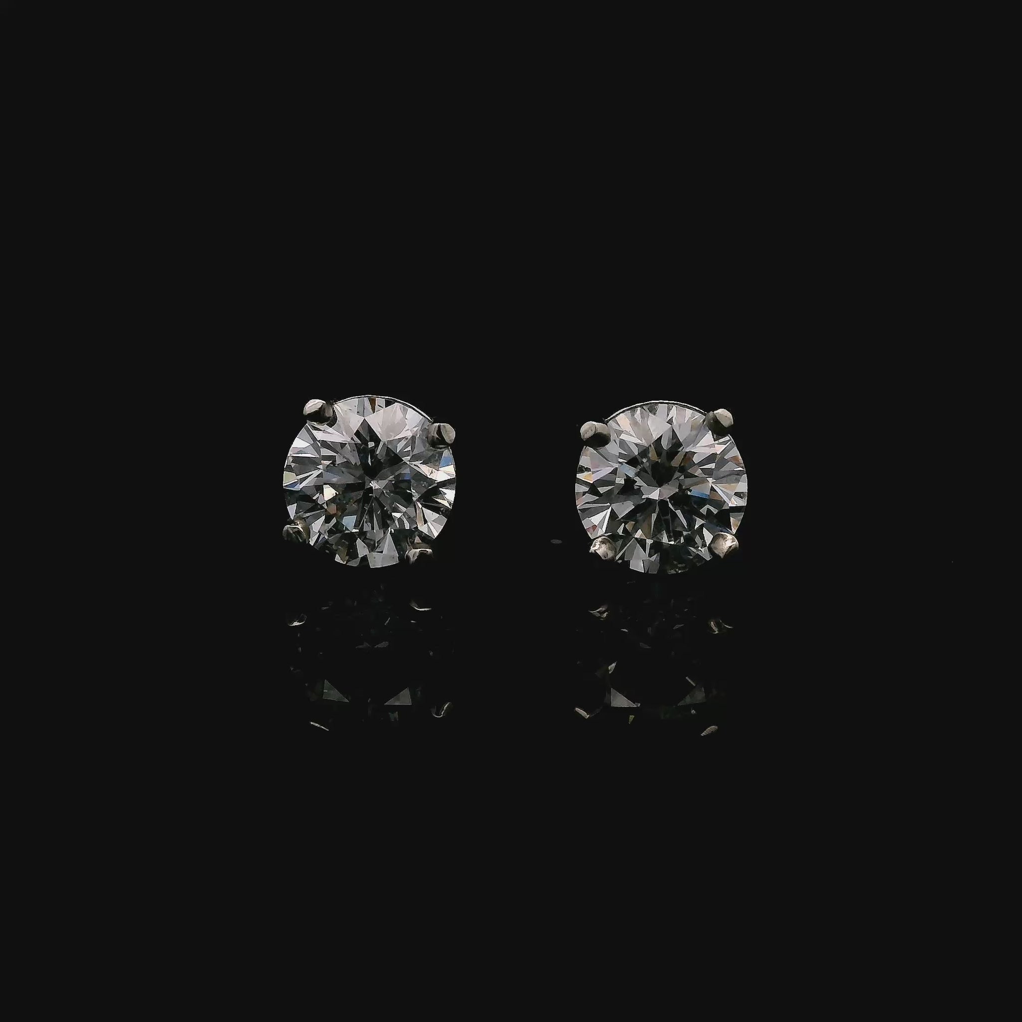 14K White gold stud earrings set with round brilliant diamonds. Item J34789 - ABC Jewelry Co.