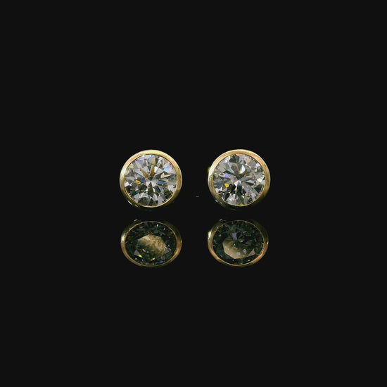 Yellow gold bezel set stud earrings set with round brilliant diamonds