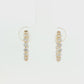 18K Yellow gold hoop earrings set with round brilliant diamonds. Item J38919 - ABC Jewelry Co.
