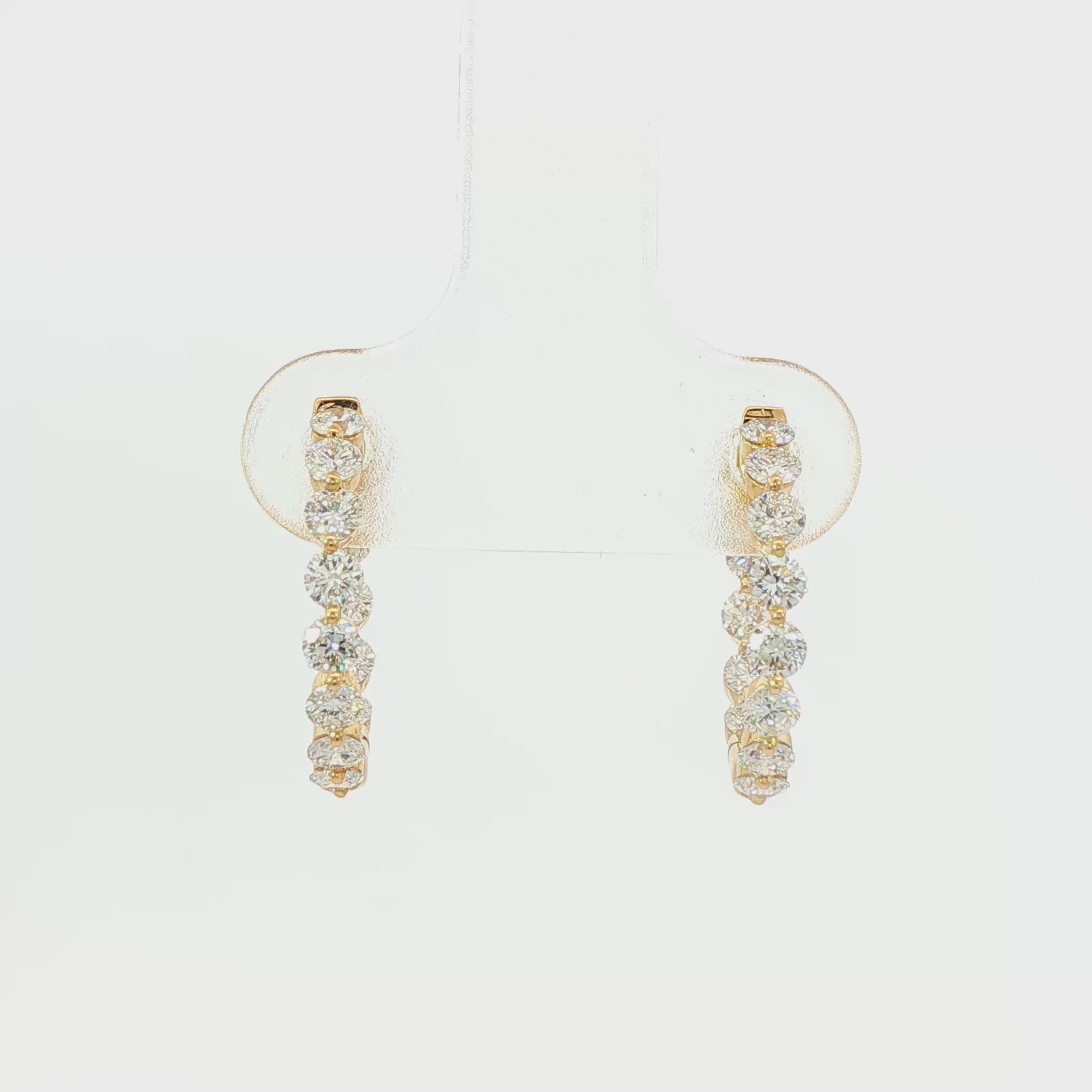 18K Yellow gold hoop earrings set with round brilliant diamonds. Item J38919 - ABC Jewelry Co.