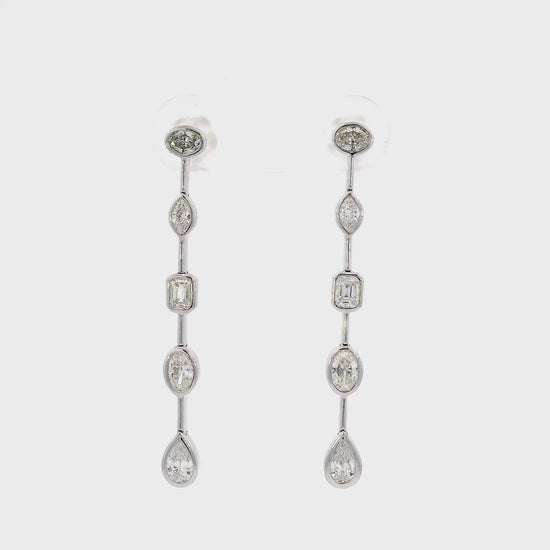 18K White gold dangle earrings featuring diamonds of assorted shapes. Item J37723 - ABC Jewelry Co