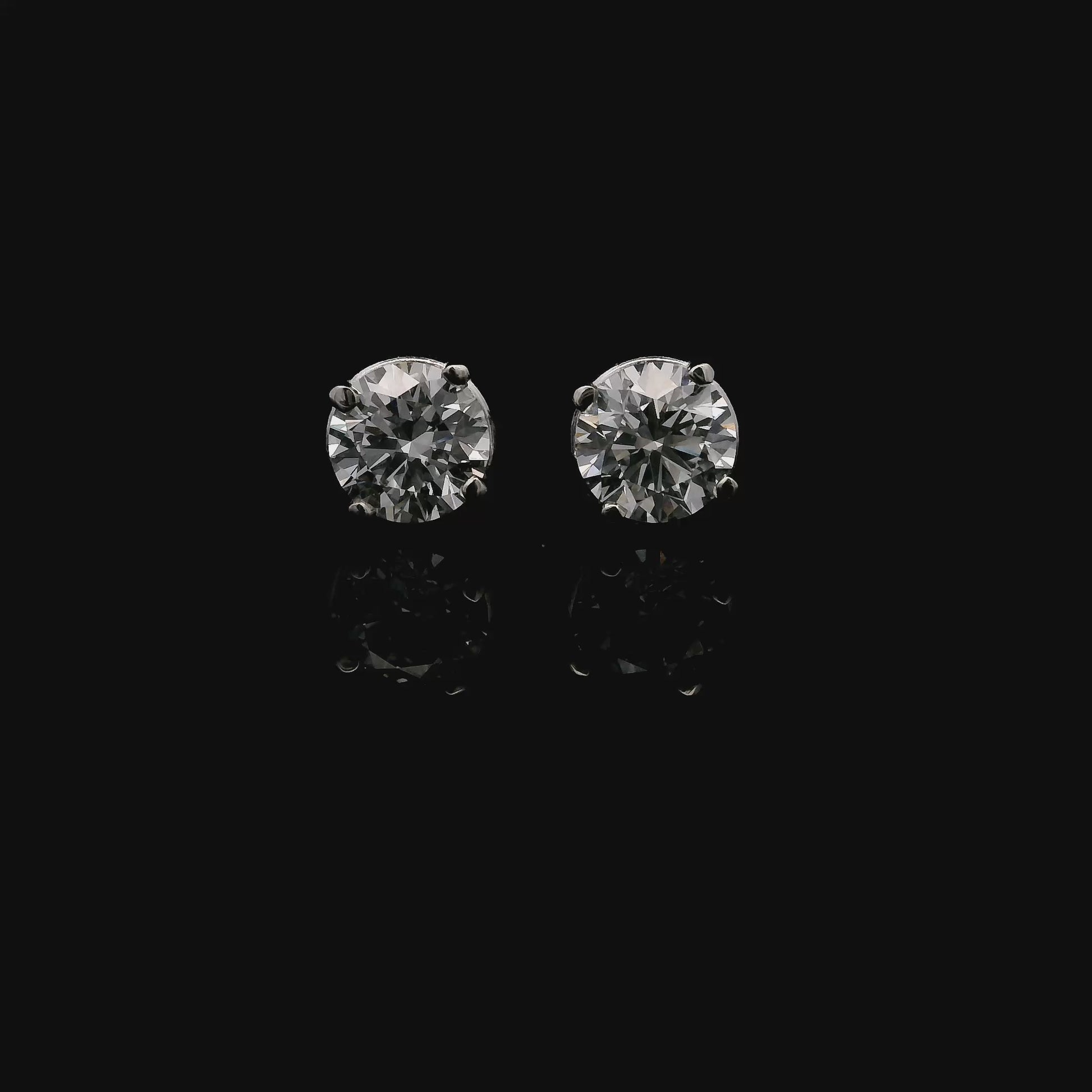 14K White gold stud earrings set with 2 round brilliant diamonds. Item J34919 - ABC Jewelry Co. 