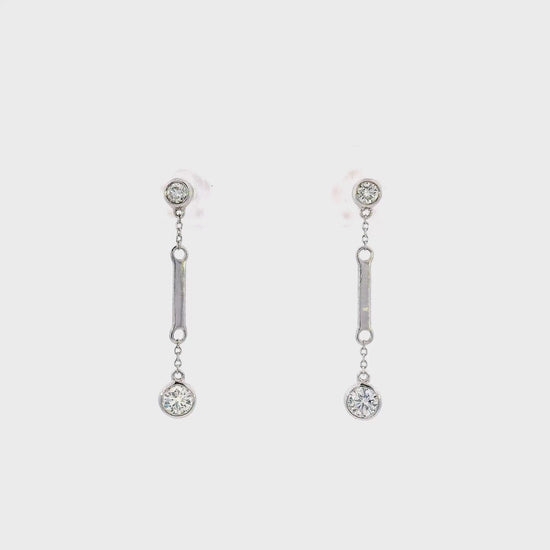 18K White gold dangle earrings with bezel set round brilliant diamonds. Item J36883 - ABC Jewelry Co. 