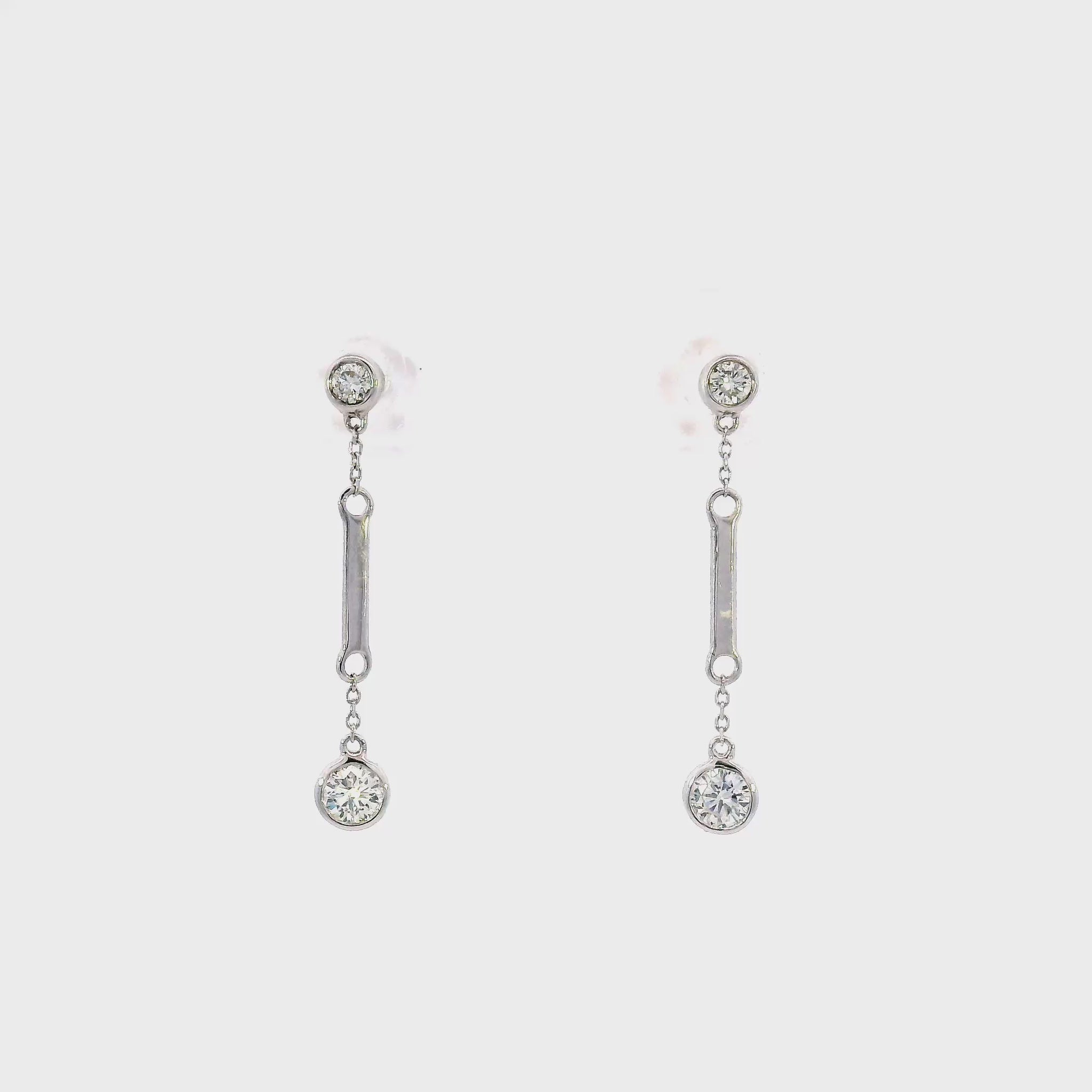 18K White gold dangle earrings with bezel set round brilliant diamonds. Item J36883 - ABC Jewelry Co. 