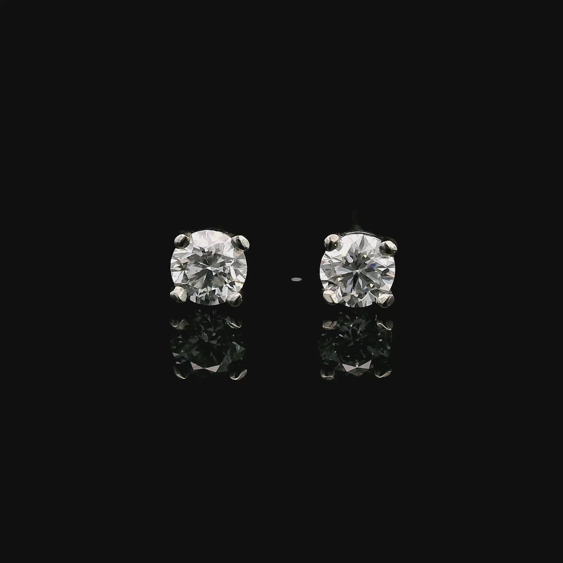 14K White gold stud earrings set with round brilliant diamonds. Item J39014 - ABC Jewelry Co. 