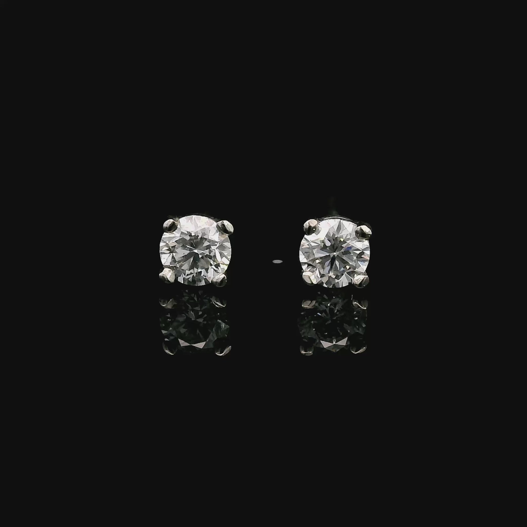 14K White gold stud earrings set with round brilliant diamonds. Item J39014 - ABC Jewelry Co. 