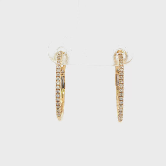 14K Yellow gold hoop earrings set with round brilliant diamonds. Item J38771 - ABC Jewelry Co