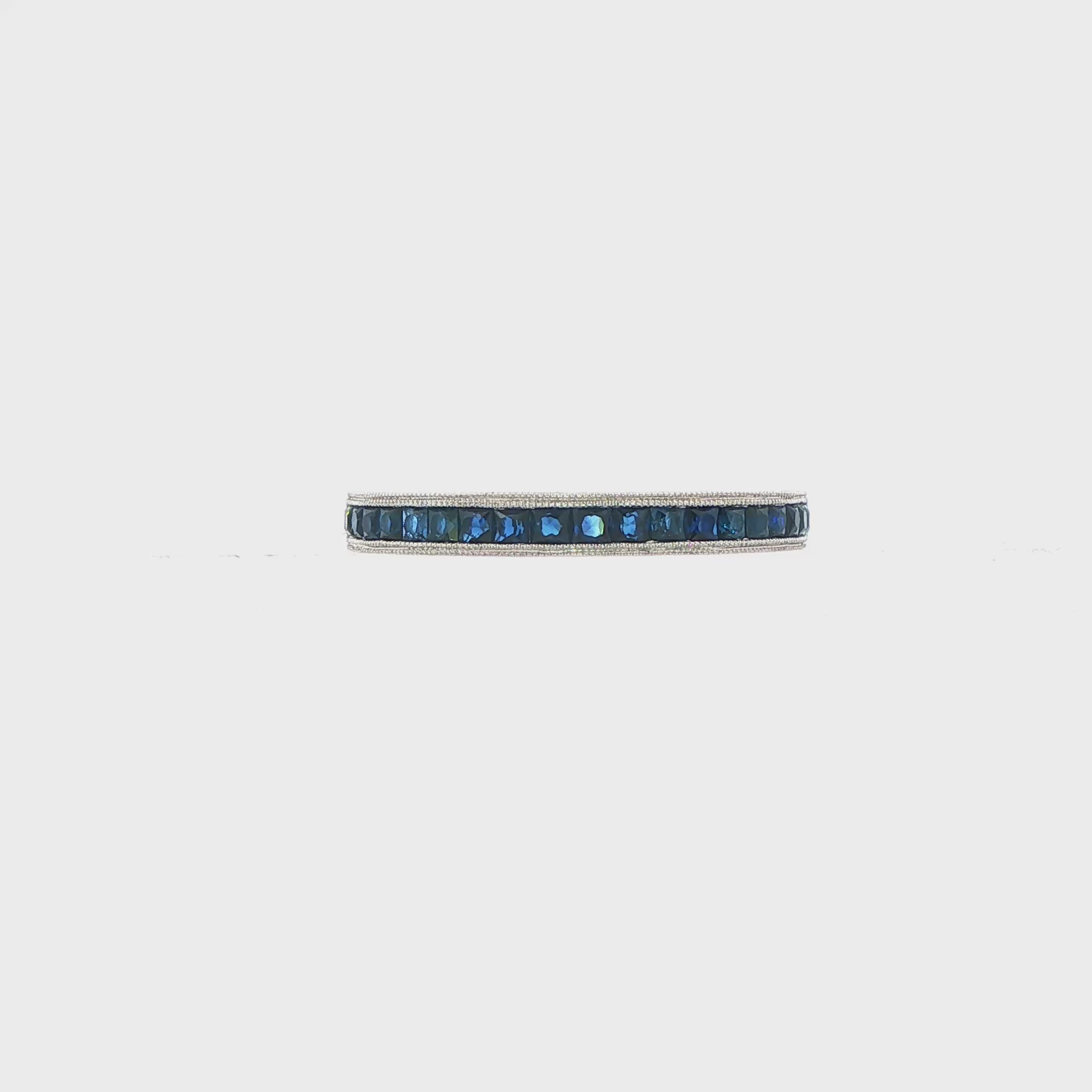 14K White gold band channel set with princess cut blue diamonds. Item 17614 - ABC Jewelry Co.