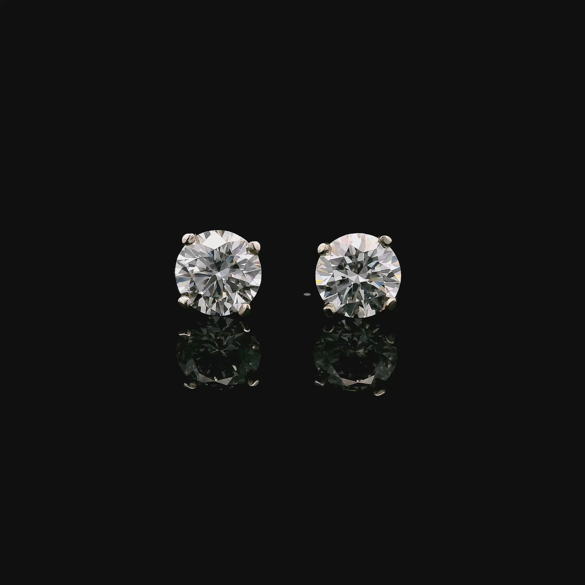 14K White gold stud earrings set with round brilliant diamonds. Item J37804 - ABC Jewelry Co.