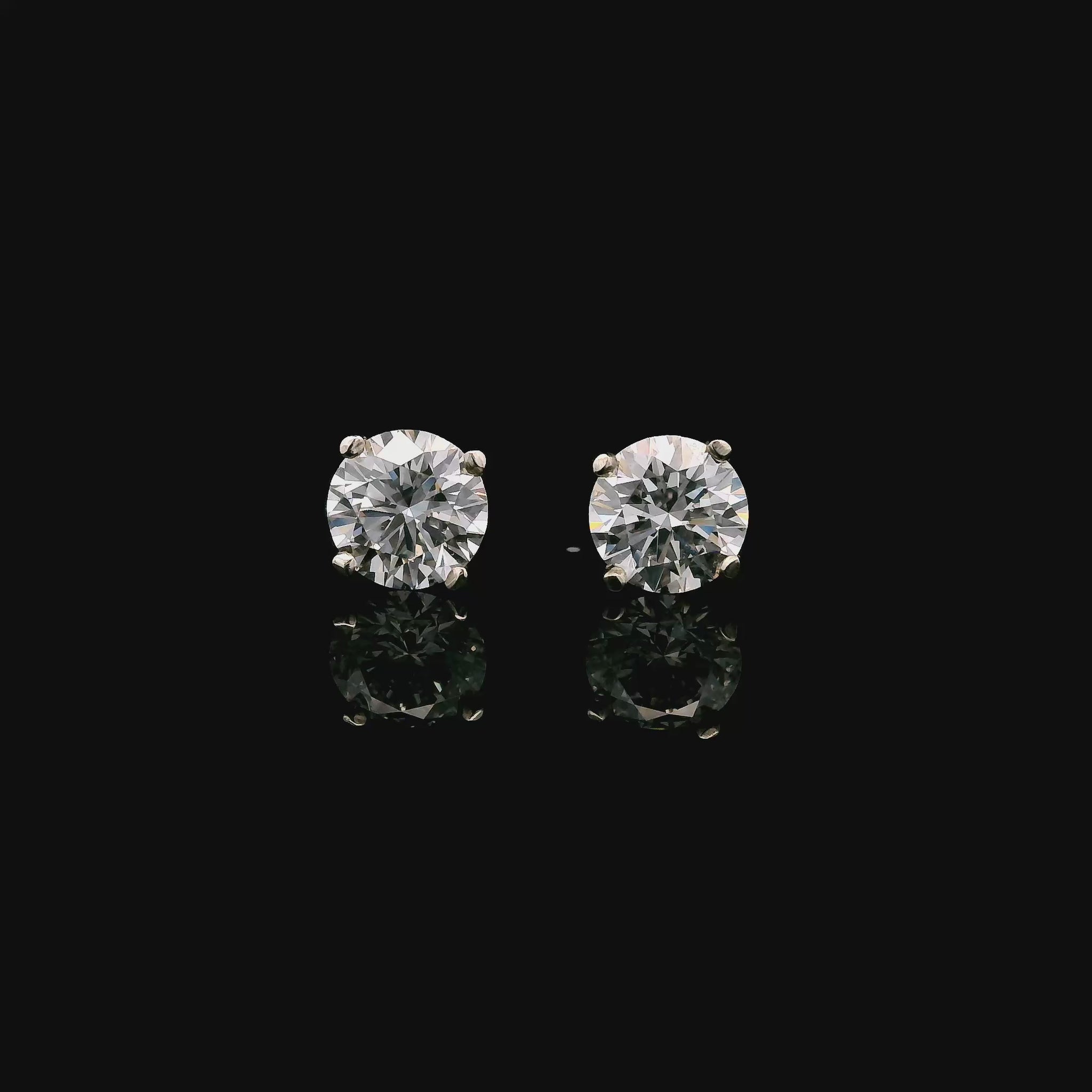 14K White gold stud earrings set with round brilliant diamonds. Item J37804 - ABC Jewelry Co.