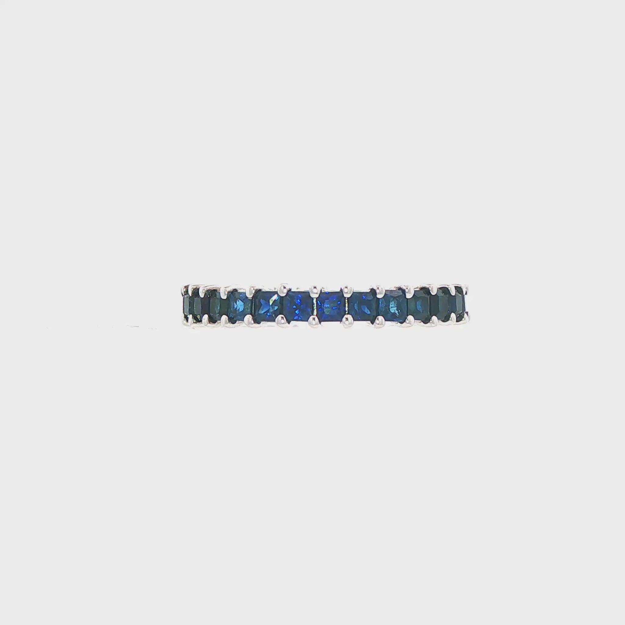 14K White gold eternity band set with princess cut blue sapphires. Item J36403 - ABC Jewelry Co.