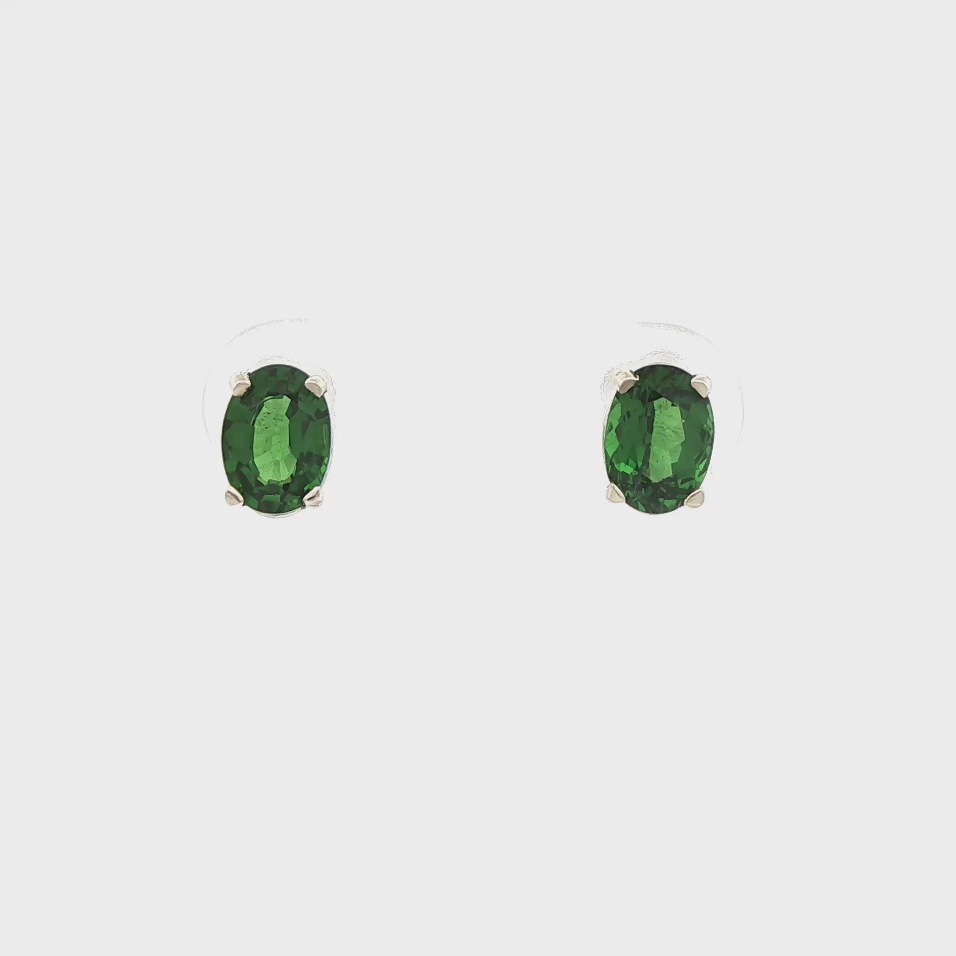 14K White gold stud earrings set with oval cut green tsavorites. Item 18874 - ABC Jewelry Co. 