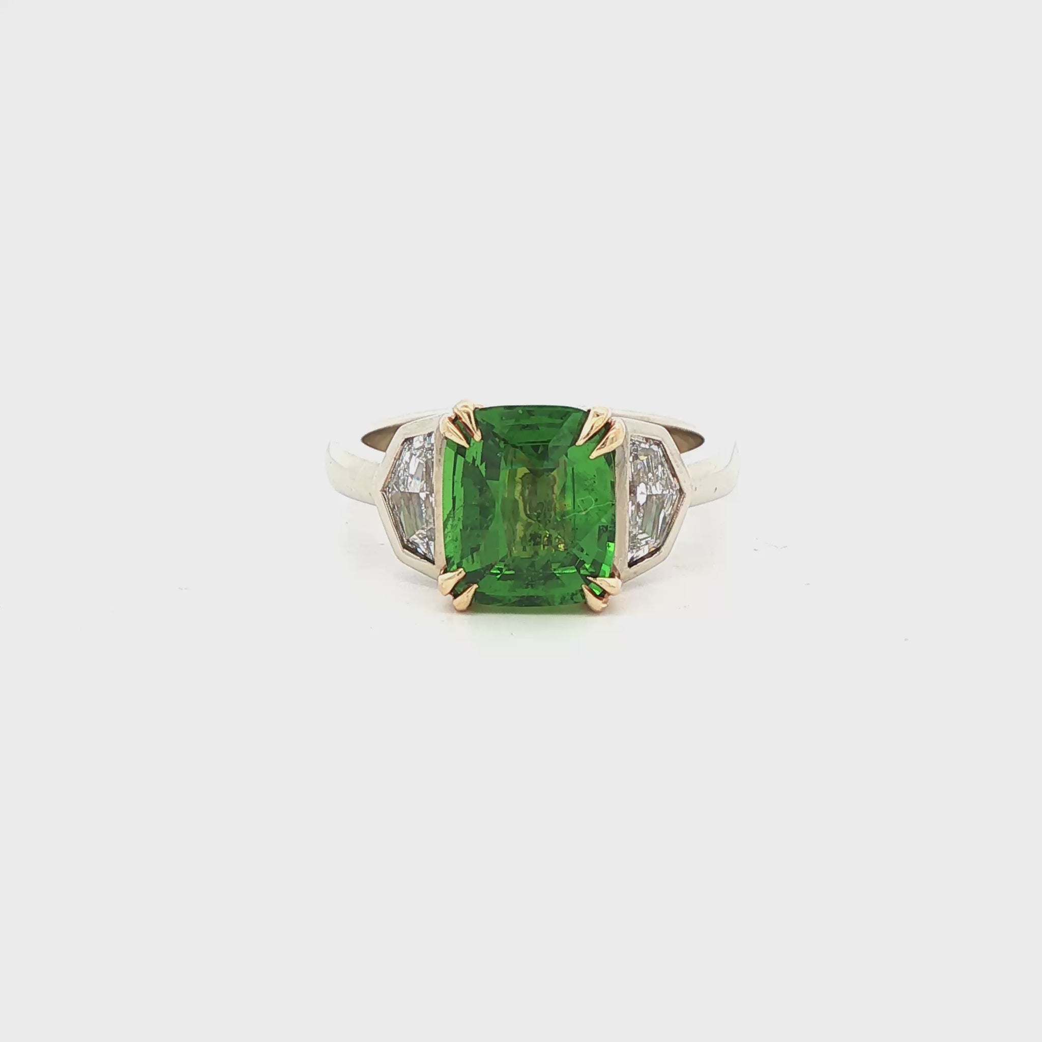 14K white & yellow gold ring set with a green tsavorite center stone and two Cadillac cut diamonds. Item #J36895 - ABC Jewelry Co.