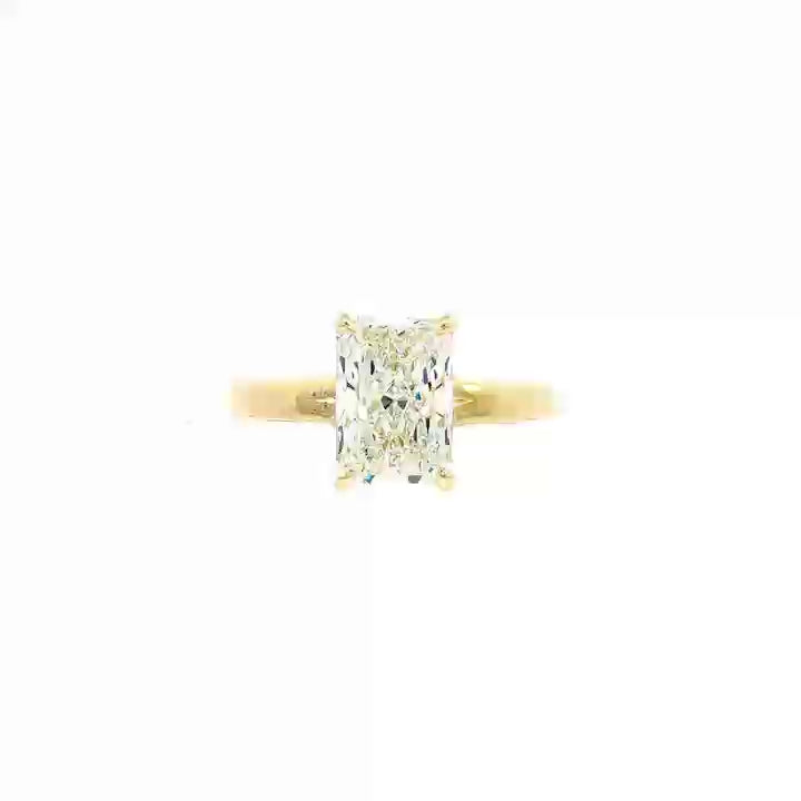 14K Yellow gold solitaire engagement ring set with radiant cut diamond. Item J37991 - ABC Jewelry Co. 