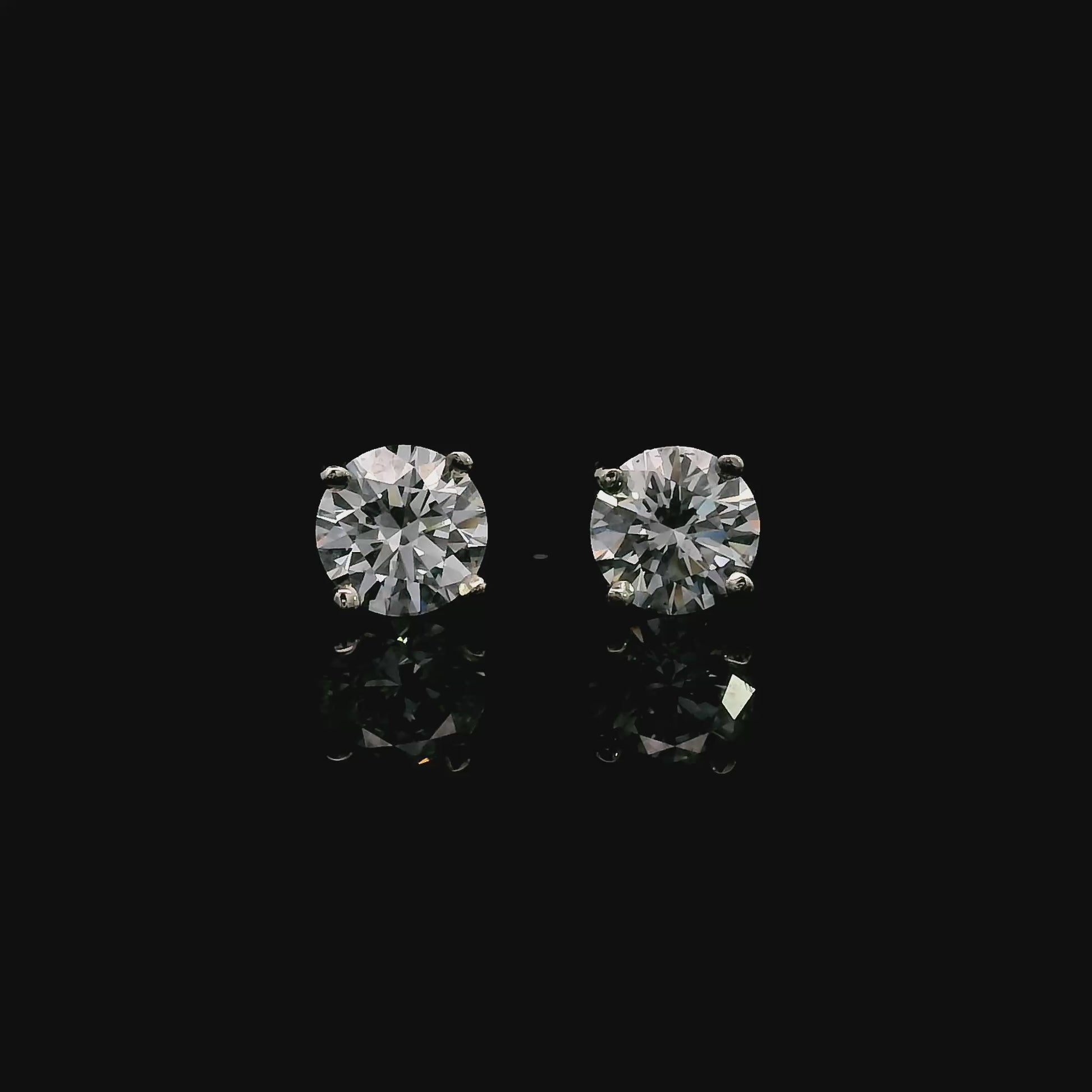 14K White gold stud earrings set with round brilliant diamonds. Item J39014 - ABC Jewelry Co. 