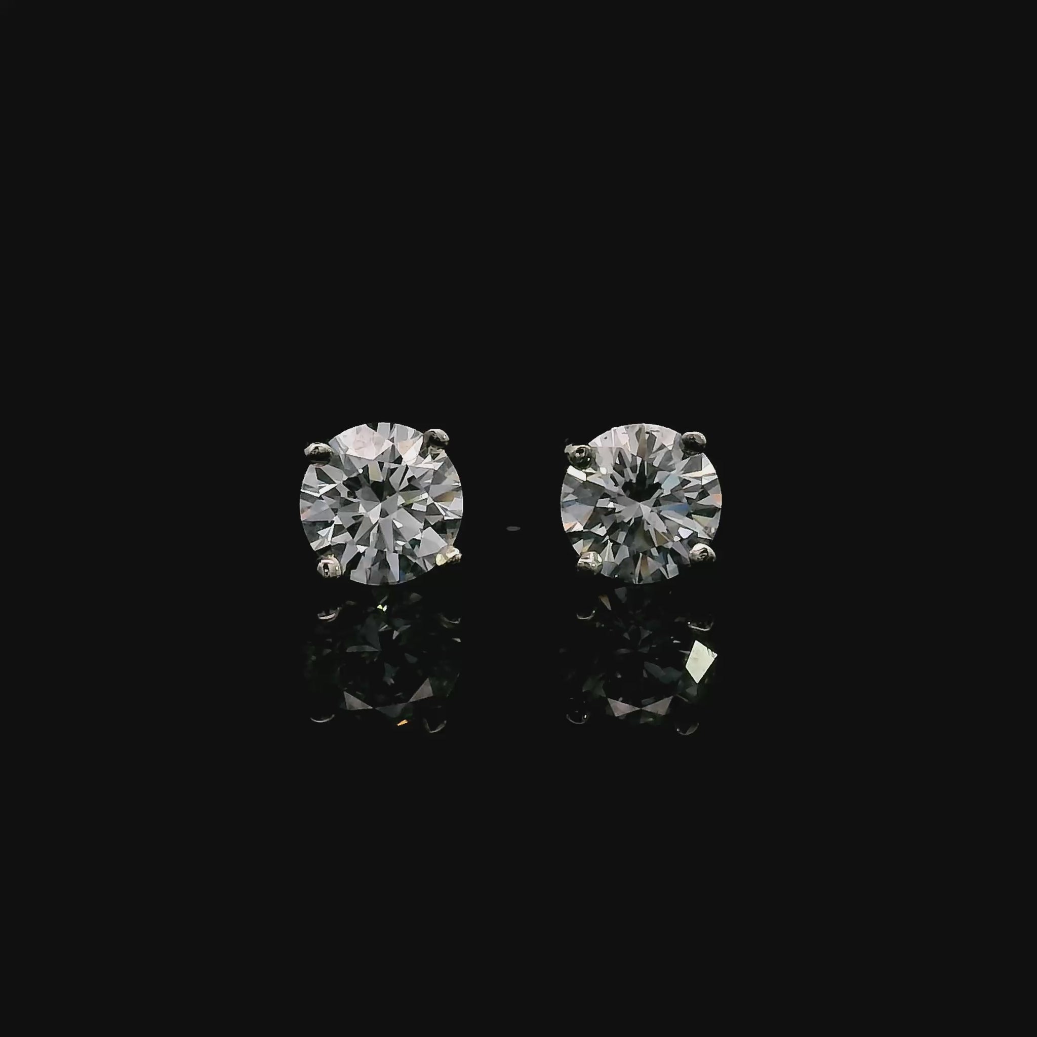 14K White gold stud earrings set with round brilliant diamonds. Item J39014 - ABC Jewelry Co. 